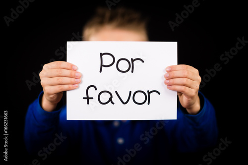 Child holding sign with Spanish words Por Favor - Please