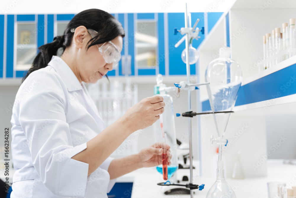 Serious professional chemist working in the lab Serious professional chemist working in the lab