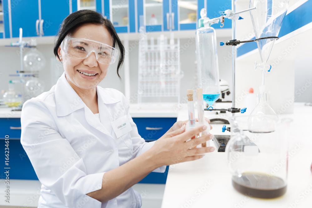 Positive female chemist enjoying her job Positive female chemist enjoying her job