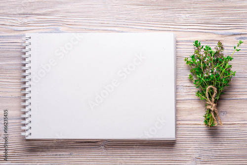 Empty notebook for your text, on wood background
