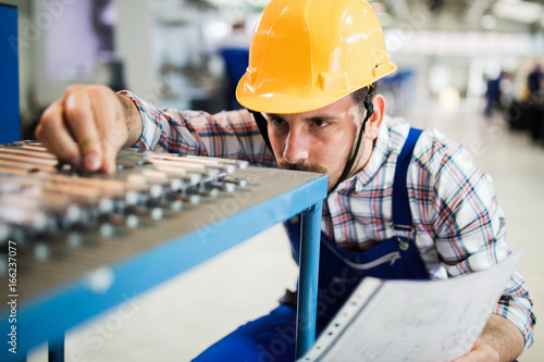 Supervisor doing quality control and pruduction check in factory photo