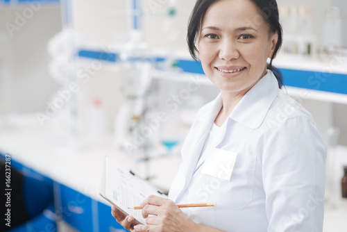 Cheerful delighted researcher looking at you