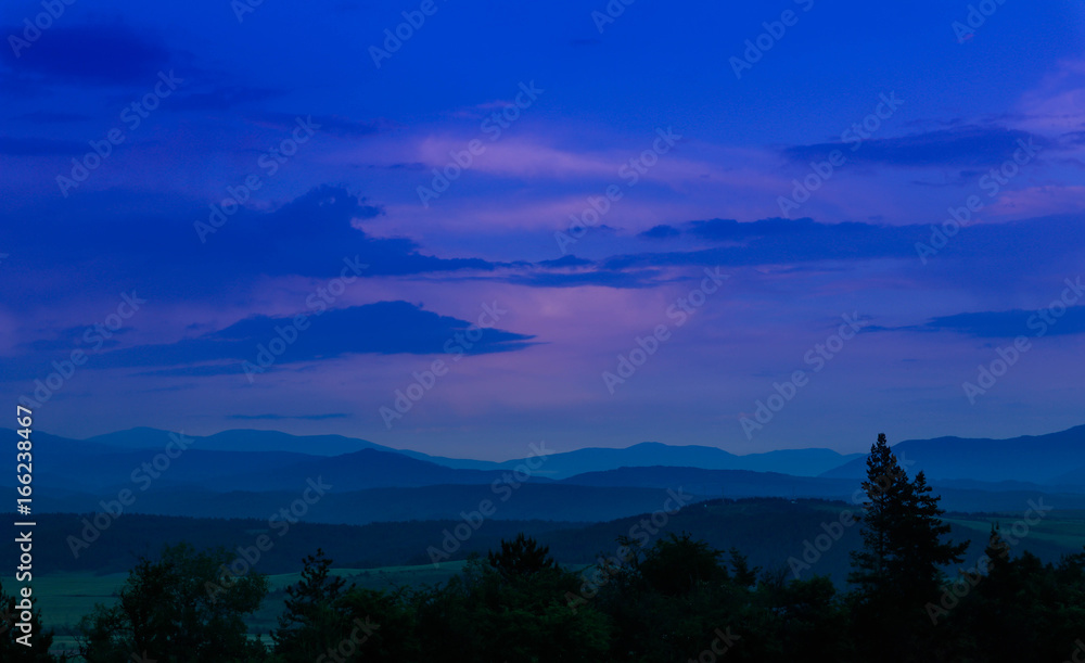 Naklejka premium Photo depicting beautiful a foggy mystic mountains. Fog clouds at the pine tree mystical woods, morning. Europe, Bulgaria, mysterious Balkan landscape.