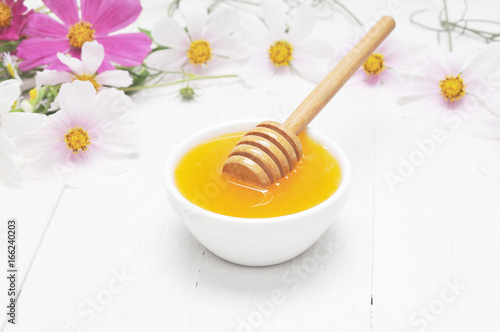 Still life of fresh honey and flowers