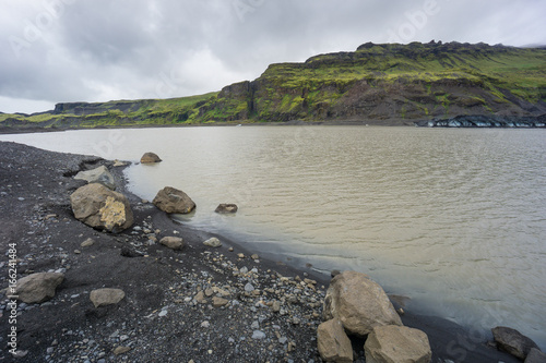 Iceland - Moss covered volcanic mountains at fjallsarlon glacier lagoon photo