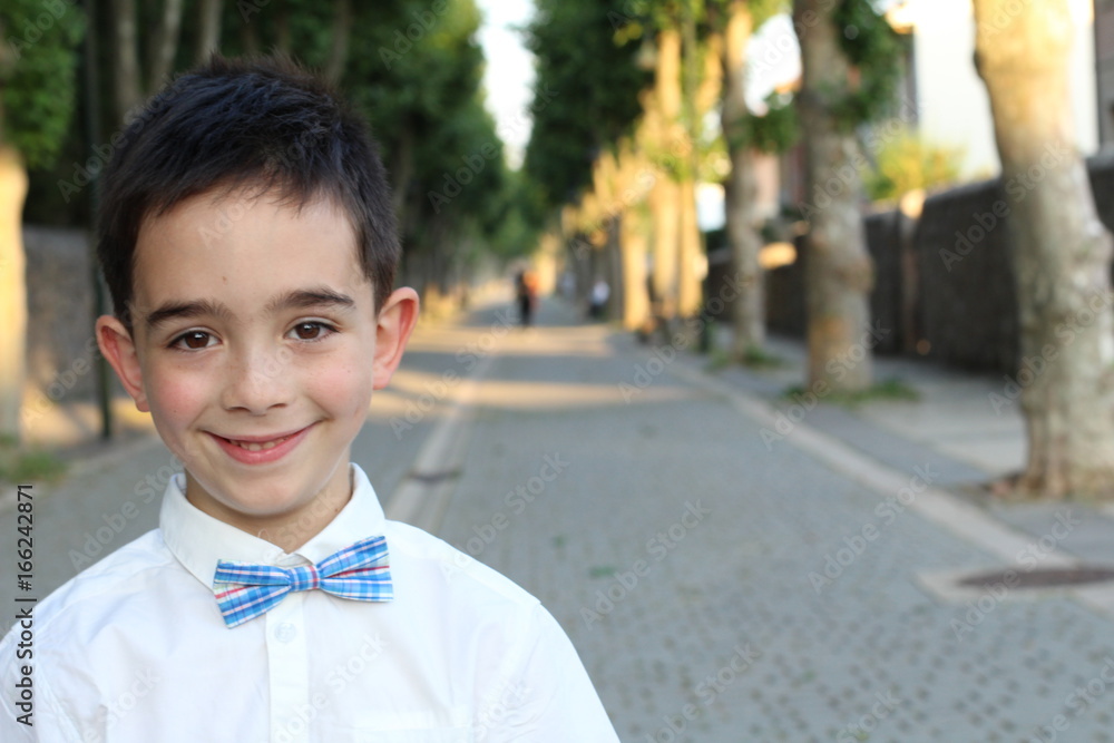 Elegant boy wearing shirt and bow tie with copy space Elegant boy wearing shirt and bow tie with copy space