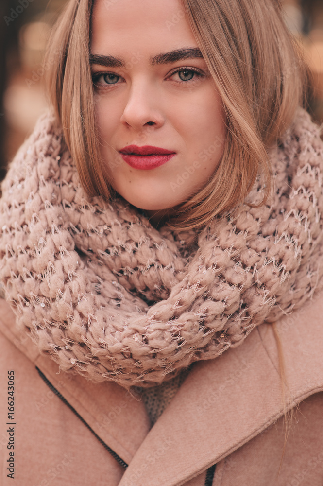 portrait of young beautiful woman walking in stylish warm outfit in sunny autumn day in park, wearing pink coat and knitted snood. Casual lifestyle in the city portrait of young beautiful woman walking in stylish warm outfit in sunny autumn day in park, wearing pink coat and knitted snood. Casual lifestyle in the city