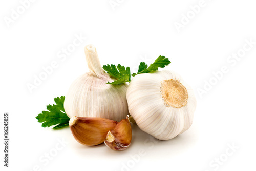 garlic with parsley leaves on a white