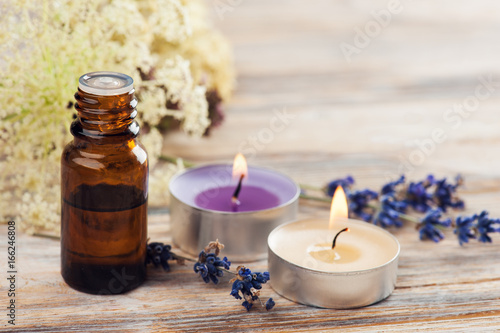 Spa composition with essential oil and lit candles