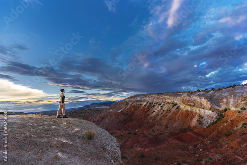 Woman standing at the edge of a big canyon in the southwest 