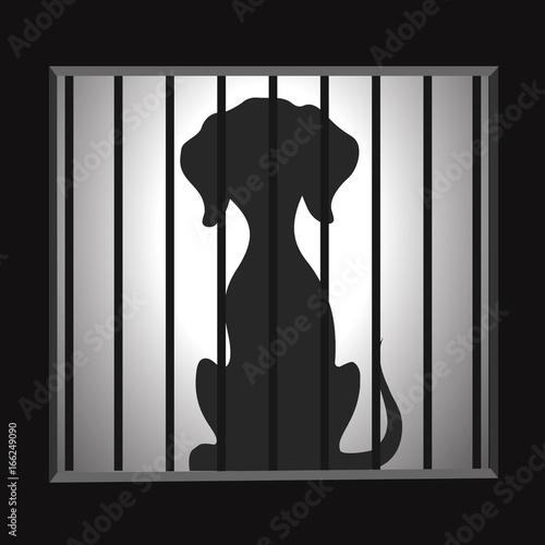 Silhouette of a dog in a cage.