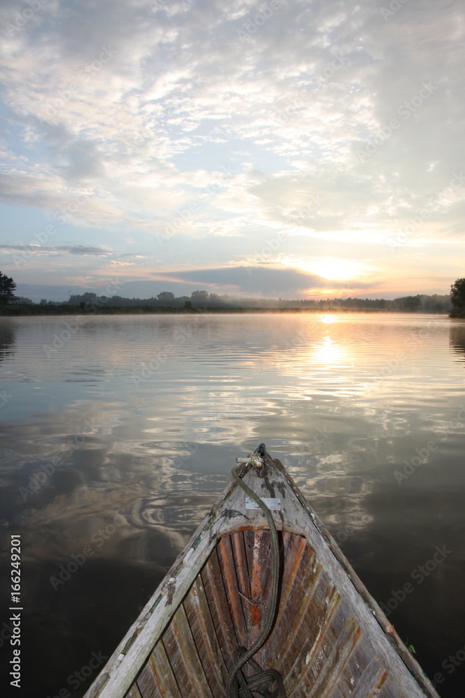 Canoe on a river at sunrise