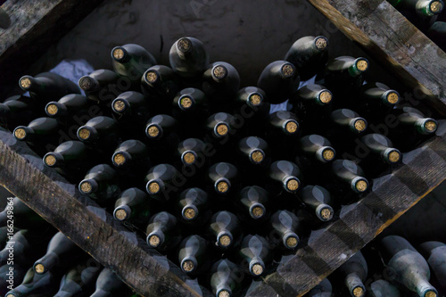 Stacked of old bottles in the cellar