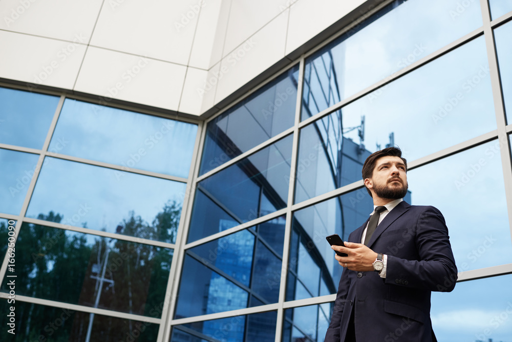 Businessman with smartphone in hand Businessman with smartphone in hand