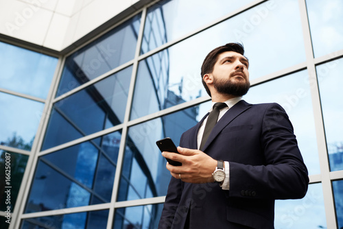 Businessman with smartphone in hand