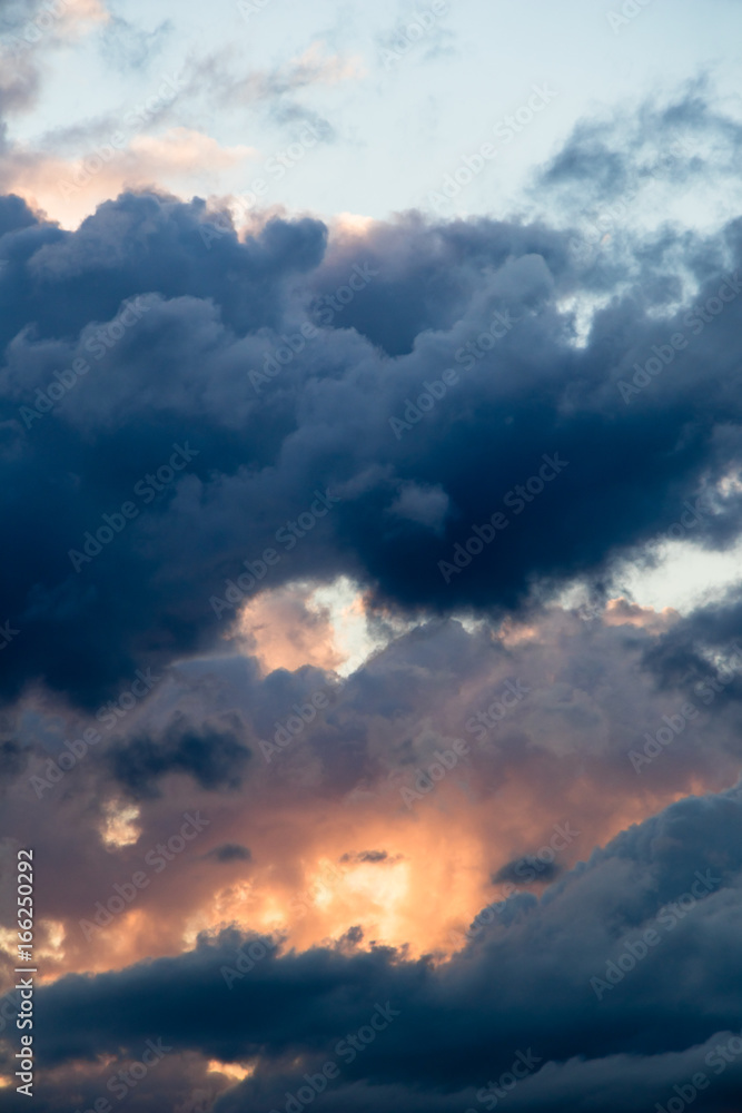 Fototapeta premium magical sky with smoky stratocumulus clouds at sunset - eyes from the clouds