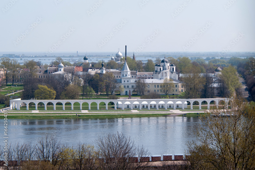 Fototapeta premium View of Yaroslav's court, the trade bank and flooded river Maly Volkhovets from the Kokuy tower, Veliky Novgorod, Russian Federation