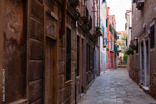 view of a small narrow street situated in a less visited part of italian city venice © Angelov