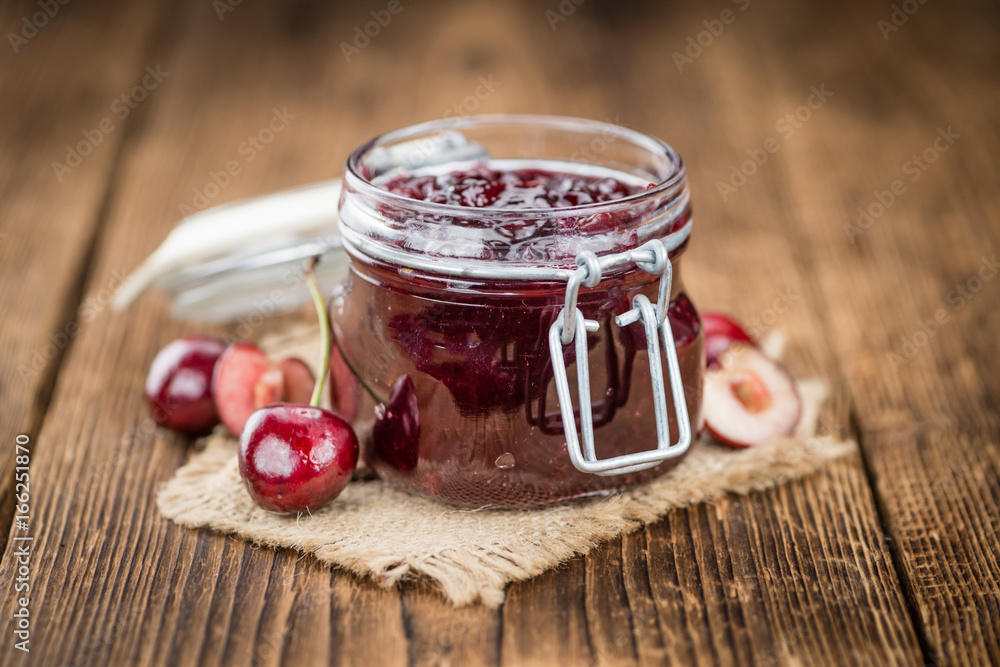 Fresh made Cherry Jam on a rustic background Fresh made Cherry Jam on a rustic background