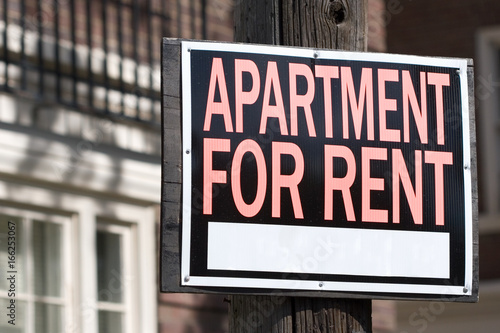 apartment for rent sign in an urban setting