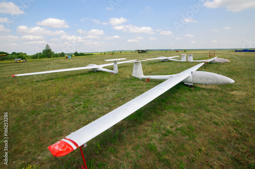 Gliders standing on meadow on airport