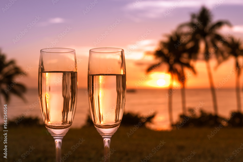 Beautiful sunset, beach and glass of champagne. Romantic destination. 