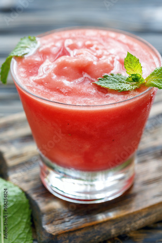 Watermelon smoothie in a glass beaker.