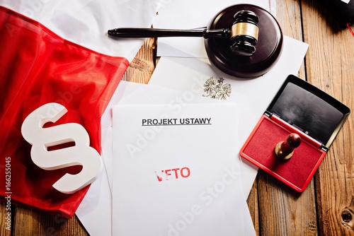 Red veto stamp on law act and Polish flag