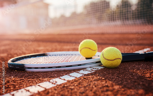 Tennis ball with racket on the tennis court. Sport, recreation concept