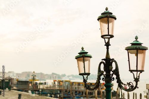 Coast with streetlights, blue sky background in Venice © Angelov