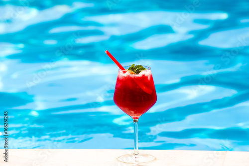 Cold red cocktail near the swimming pool