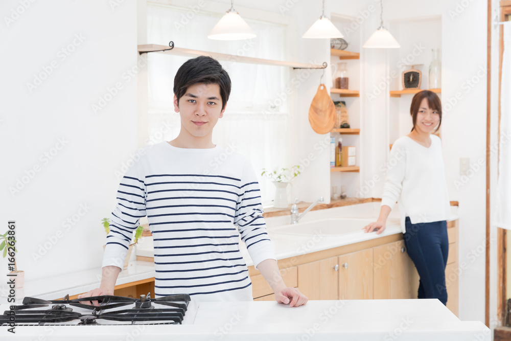 portrait of young asian couple in kitchen portrait of young asian couple in kitchen