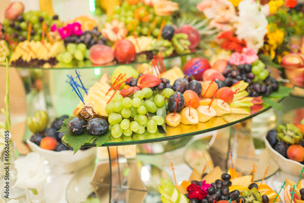 Different fresh fruits on wedding buffet table Different fresh fruits on wedding buffet table