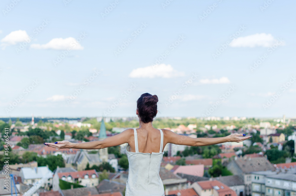 tranquility scene of woman on big elevation looking her city