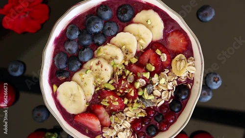 rotating acai berry bowl with fruits, close