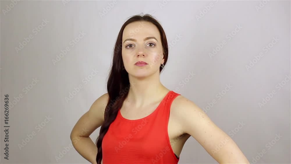 Young beautiful woman looks at the camera and winks Young beautiful woman looks at the camera and winks