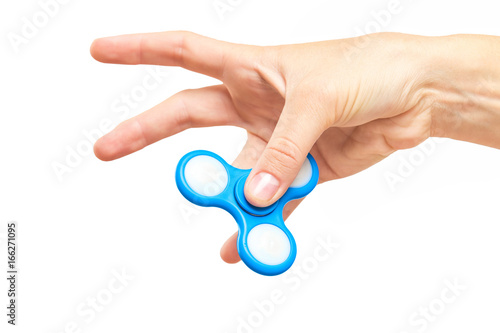 Closeup female hand holding fidget spinner with thumb. Popular antistress toy for relaxing.