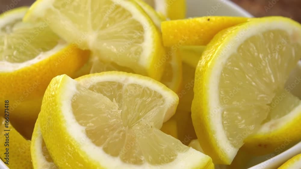 Portion of Lemon slices rotating on a wooden plate (not loopale; 4K) Portion of Lemon slices rotating on a wooden plate (not loopale; 4K)