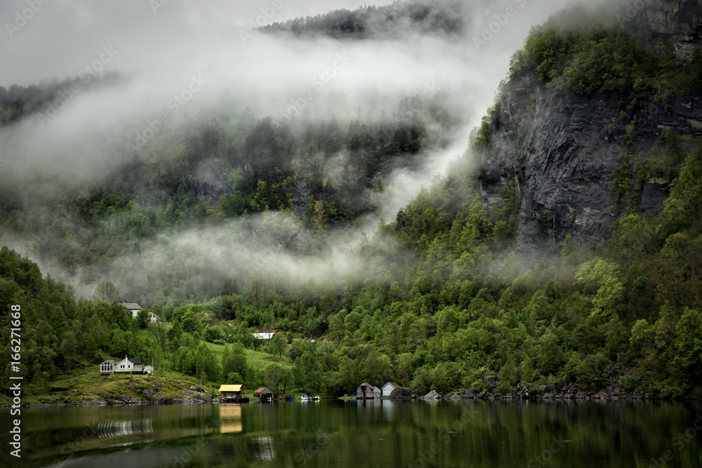 Low cloud clinging to the mountainside in the fjord near Bergen in Norway
