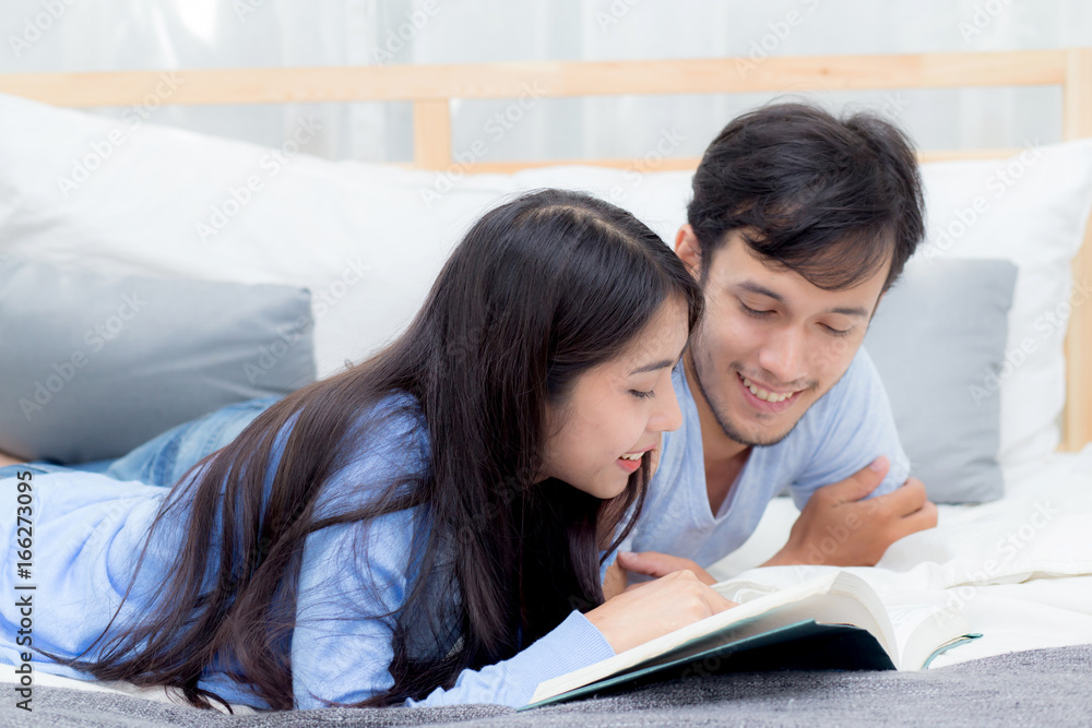 Couple reading a book together in bedroom on the morning with happiness. Couple reading a book together in bedroom on the morning with happiness.
