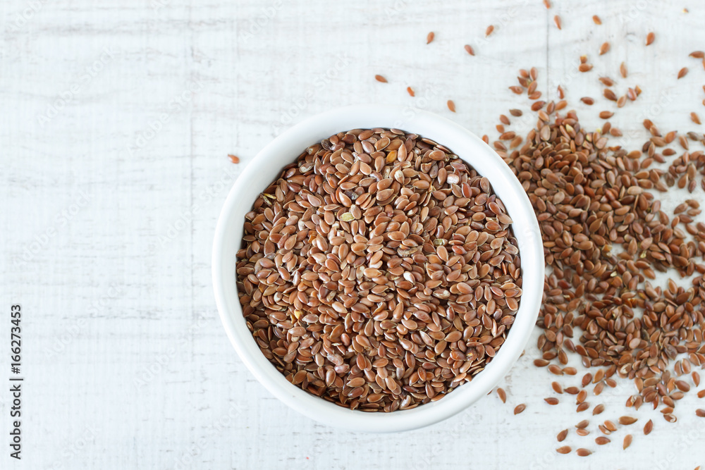 Superfood: flax seeds in a white bowl. Top view Superfood: flax seeds in a white bowl. Top view