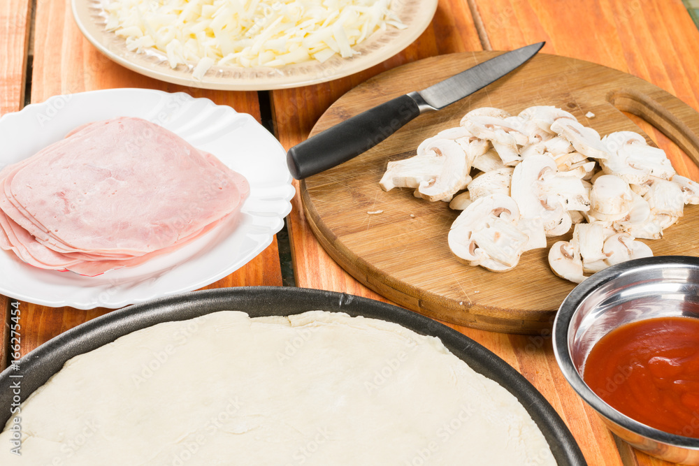 Pizza dough with pizza ingredients mushrooms sliced ham cheese Pizza dough with pizza ingredients mushrooms sliced ham cheese