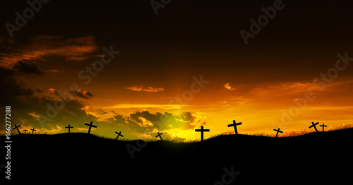 Sun rising on three Christian crosses.