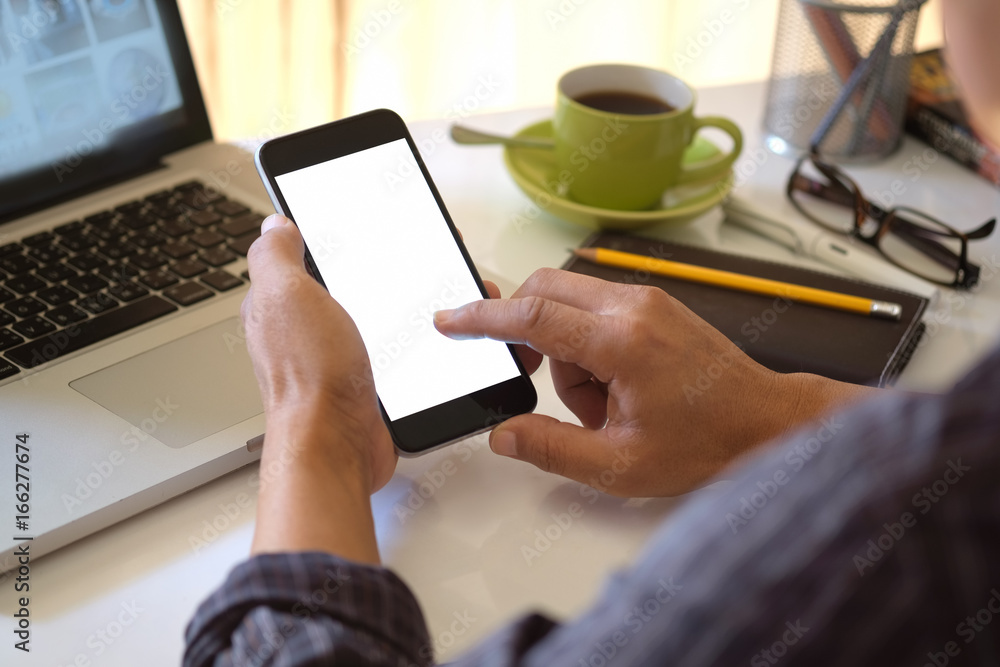 Man holding the smartphone with blank on the screen in the office. Man holding the smartphone with blank on the screen in the office.