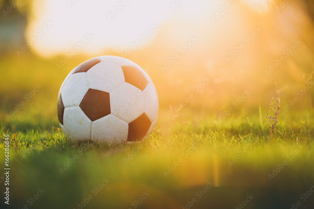 Obraz premium A ball for street soccer football under the sunset ray light. Concept for sport and exercise for kids.Picture with copy space.