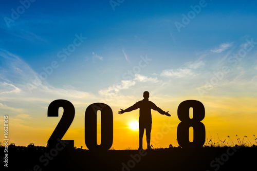 Man raise hand in 2018 number of happy new year on sunset