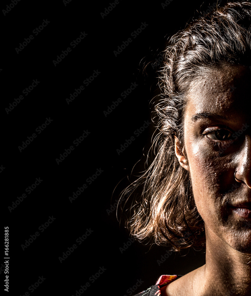Fototapeta premium Half face in the dark of night of woman warrior