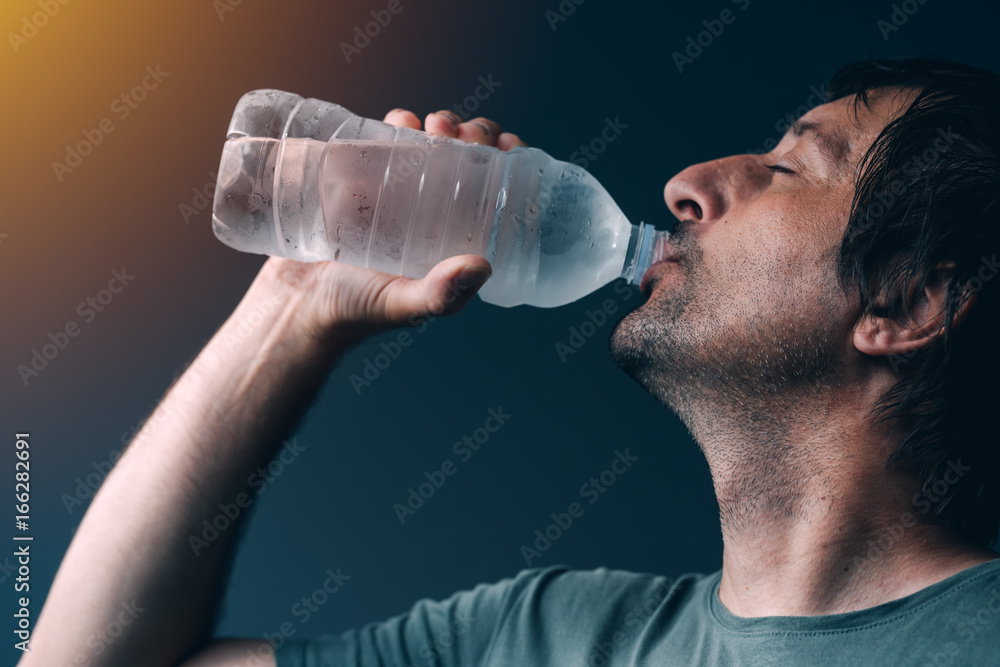 Man drinking water from the bottle Man drinking water from the bottle