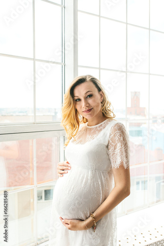 Beautiful adult pregnant woman. Waiting for the baby. Pregnancy. Care, tenderness, motherhood, childbirth.