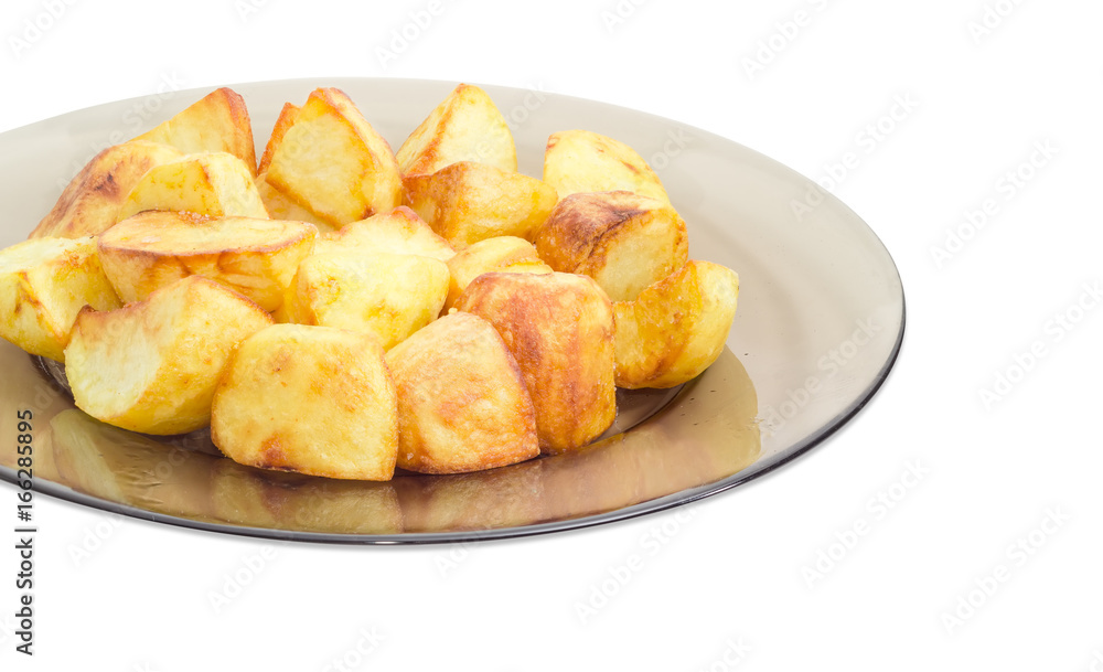 Fried potatoes on the dark glass dish